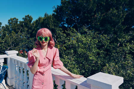 woman in pink dress and green glasses fashion summer posing