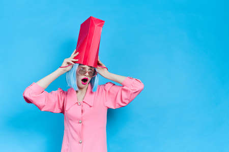 glamorous emotional woman with a package on her head