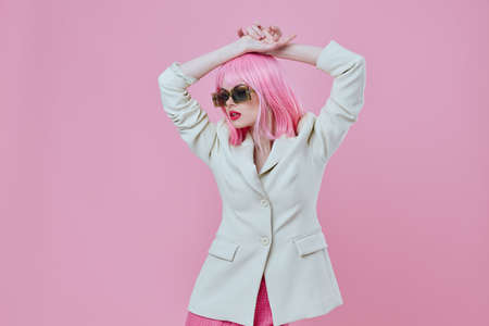 Positive young woman in White blazer pink hair Glamor Cosmetics pink background unalteredの写真素材