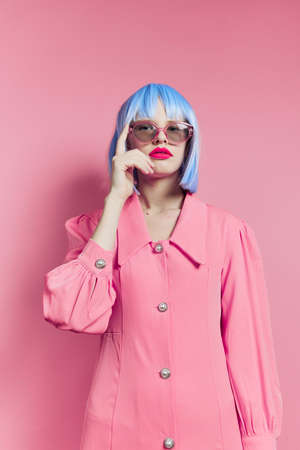 fashionable woman in blue wig pink dress red lips studio modelの写真素材