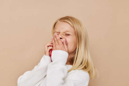 Beautiful little girl communication smartphone entertainment kids lifestyle conceptの写真素材