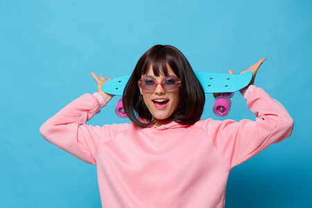beautiful woman in sunglasses with a skateboard Lifestyle fashionの写真素材