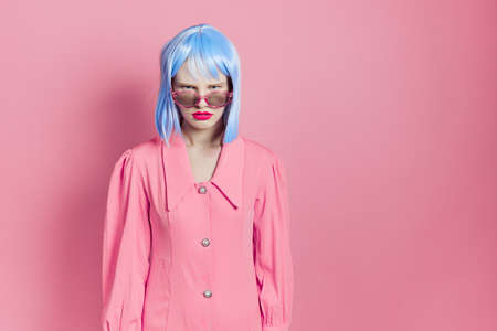 glamorous woman in blue wig pink dress red lips studio modelの写真素材