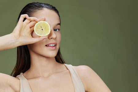 beautiful woman lemon in hands posing clean skin close-up Lifestyleの写真素材