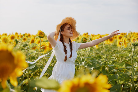 woman portrait in a straw hat in a white dress a field of sunflowers agriculture countrysideの写真素材