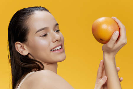 portrait woman eating grapefruit in hands smile vitamins diet close-up Lifestyleの写真素材