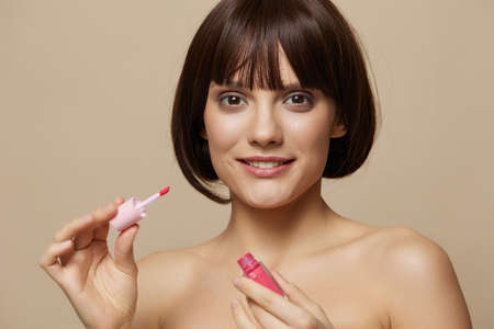 young woman smile lip makeup charm short haircut beige background
