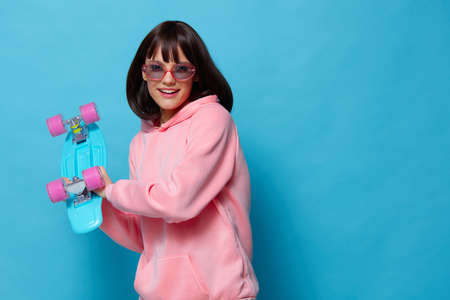 young woman teenager skateboard emotions youth style isolated backgroundの写真素材