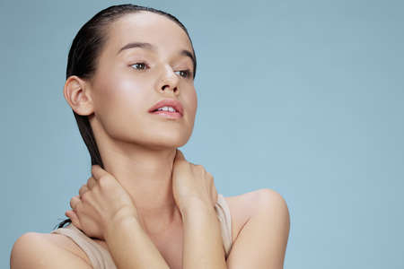 brunette touches the face skin care charm posing studio close-up Lifestyleの写真素材