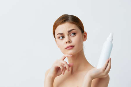 woman lotion jar clean skin health care Gray background