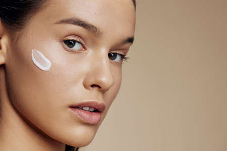 beautiful woman face mask cream clean skin facial scrub isolated backgroundの写真素材