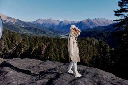 woman autumn style travel to the mountains forest nature lifestyle