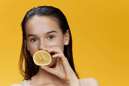 woman with lemon near face clean skin care health close-up Lifestyle