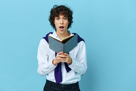 curly guy with a notepad in a sweater shirt on the shoulders isolated backgroundsの写真素材