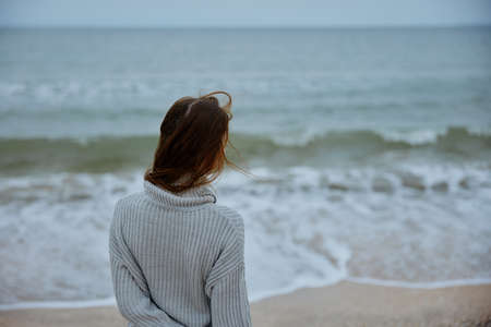woman with long hair on the beach nature landscape walk Happy female relaxingの写真素材