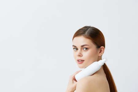 young woman skin care lotion with bare shoulders close-up Lifestyle