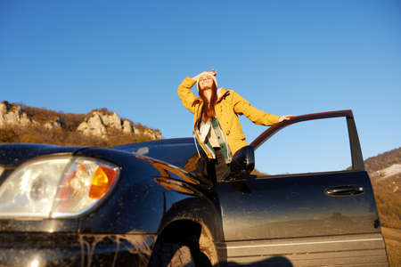 woman in a yellow jacket in a hat backpack travel mountains Lifestyleの写真素材