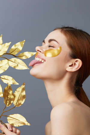 beautiful woman golden patches clean skin smile posing Charm Gray backgroundの写真素材