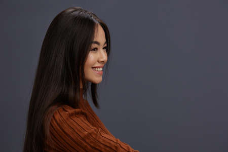 portrait woman fun brown sweater posing casual wear Gray backgroundの写真素材