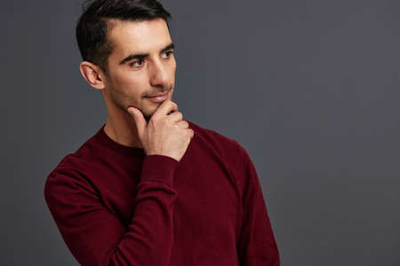 portrait man posing smile gesture hands red sweater cropped viewの写真素材