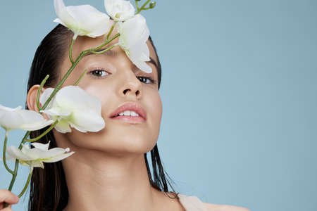 woman white flower charm pure skin posing close-up Lifestyleの写真素材