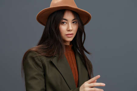woman brown hat hand gestures fashion emotions studio modelの写真素材