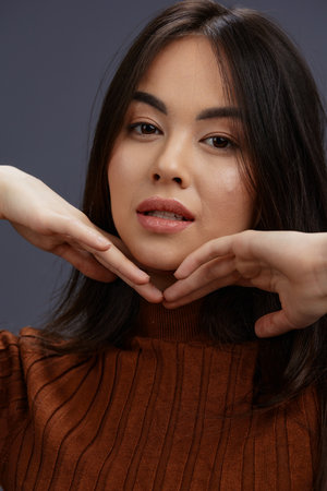 pretty woman fun brown sweater posing casual wear isolated backgroundの写真素材