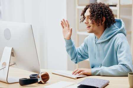 portrait of a man in a blue jacket in front of a computer Lifestyle