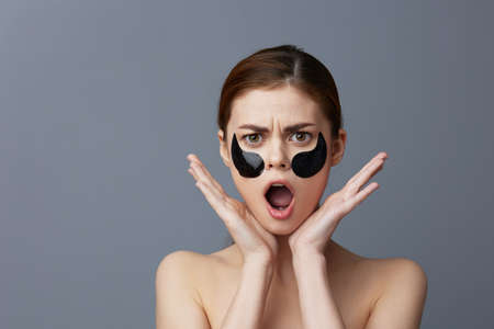 portrait woman with patches on the face clean skin health rejuvenation isolated background
