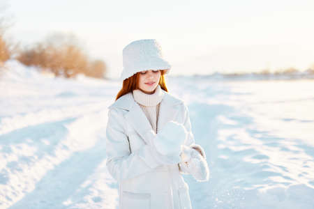 pretty woman red hair snow field winter clothes Sunny winter day Fresh airの写真素材