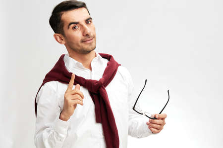 manager red sweater on shoulders glasses lifestyle light background