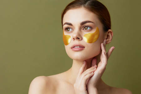 young woman golden patches on the face close-up Lifestyleの写真素材