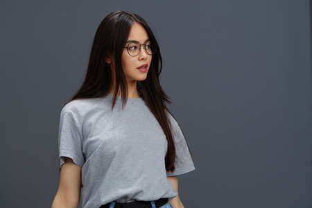 woman glasses on face fashion lifestyle gray t-shirt Gray backgroundの写真素材