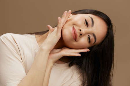 Brunette in a beige T-shirt posing clothing fashion Lifestyleの写真素材