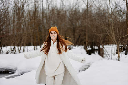 woman in winter clothes in a hat fun winter landscape Walk in the winter forestの写真素材