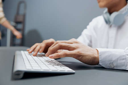 businessmen in headphones hands on keyboard office work close-up technologiesの写真素材