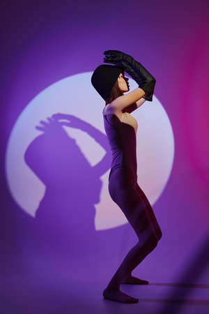 glamorous woman scene spotlight posing neon studio model unalteredの写真素材