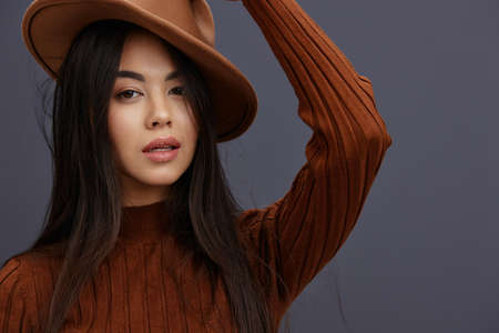 pretty woman brown sweater glamor posing smile fashion isolated backgroundの写真素材