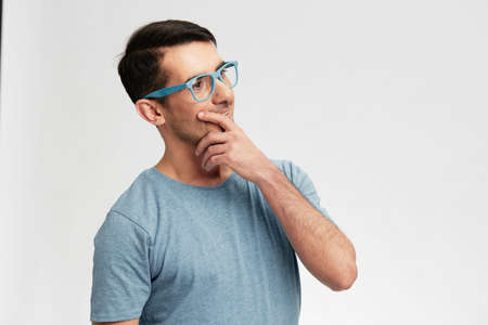 man in blue t-shirt glasses gesture hands smile emotions isolated backgroundの写真素材