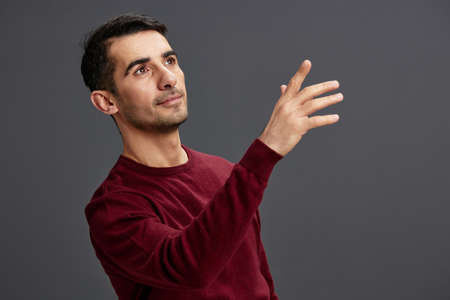 portrait man in a sweater posing emotions elegant style isolated background