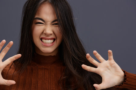 pretty woman hand gestures brown sweater fashion Lifestyleの写真素材
