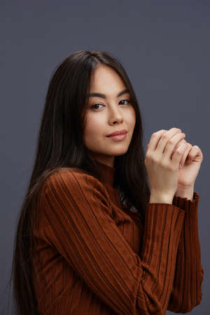 portrait woman brown sweater glamor posing smile fashion Gray background
