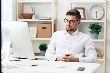 businessmen wearing glasses sits at a desk office worked technologiesの写真素材