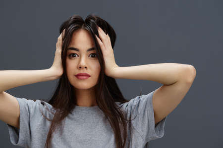 young woman casual wear gray t-shirt fashion charm isolated backgroundの写真素材