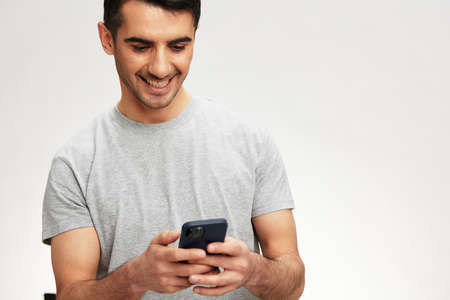 man phone conversation lifestyle smile light backgroundの写真素材