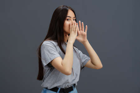 Brunette in a t-shirt and jeans posing Youth style isolated background