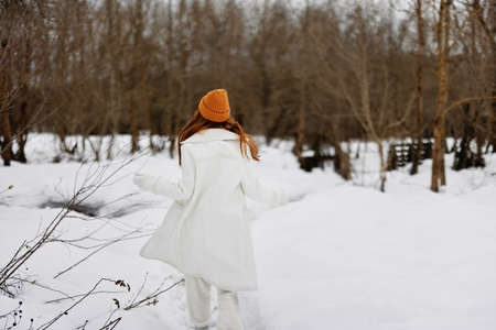 young woman Walk in winter field landscape outdoor entertainment There is a lot of snow aroundの写真素材