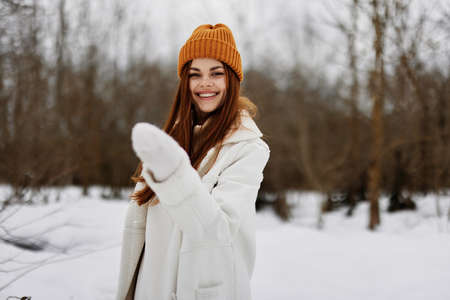 woman in winter clothes in a hat fun winter landscape Walk in the winter forestの写真素材