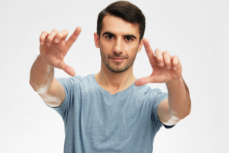 handsome man in blue t-shirts gesture hands emotion isolated background