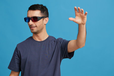 handsome man in blue t-shirt 3d glasses entertainment gesture with hands isolated background